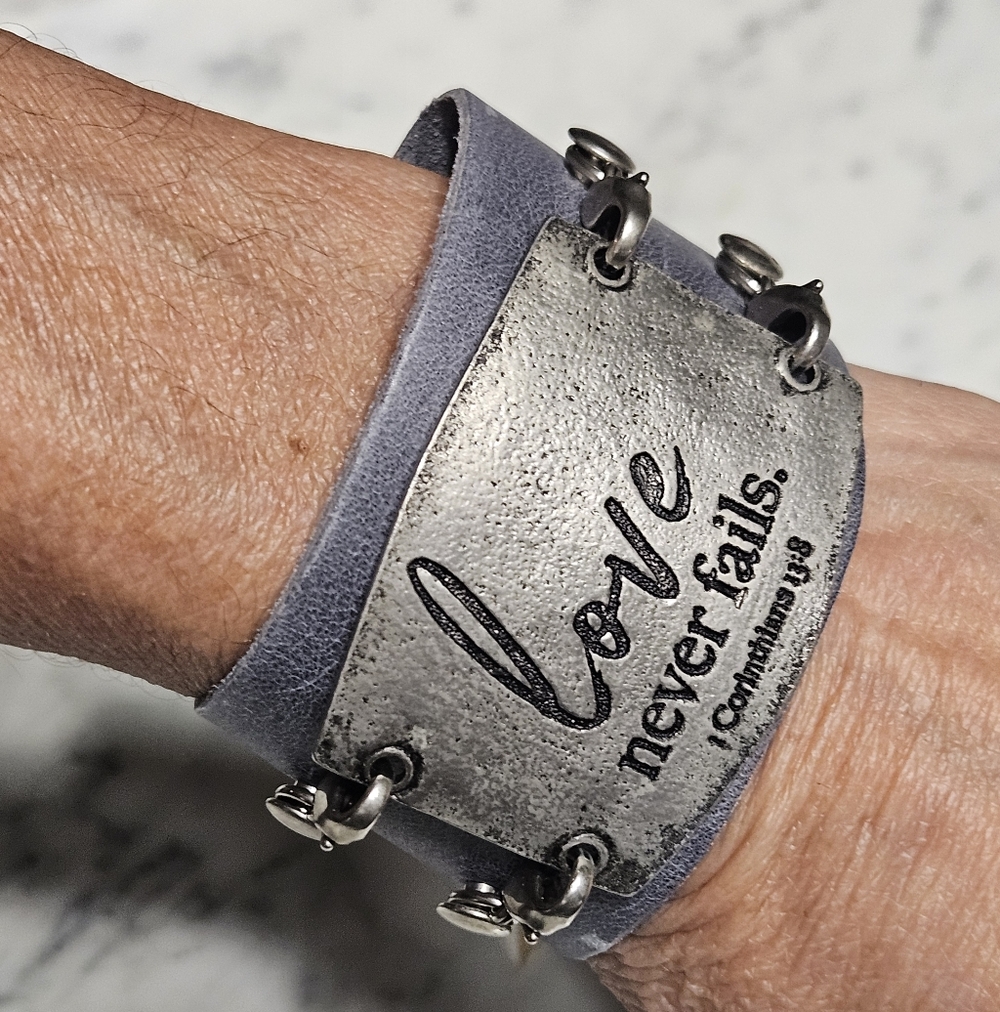 NWT - Gray Leather Bracelet with Inspirational LOVE NEVER FAILS  Quote Plate